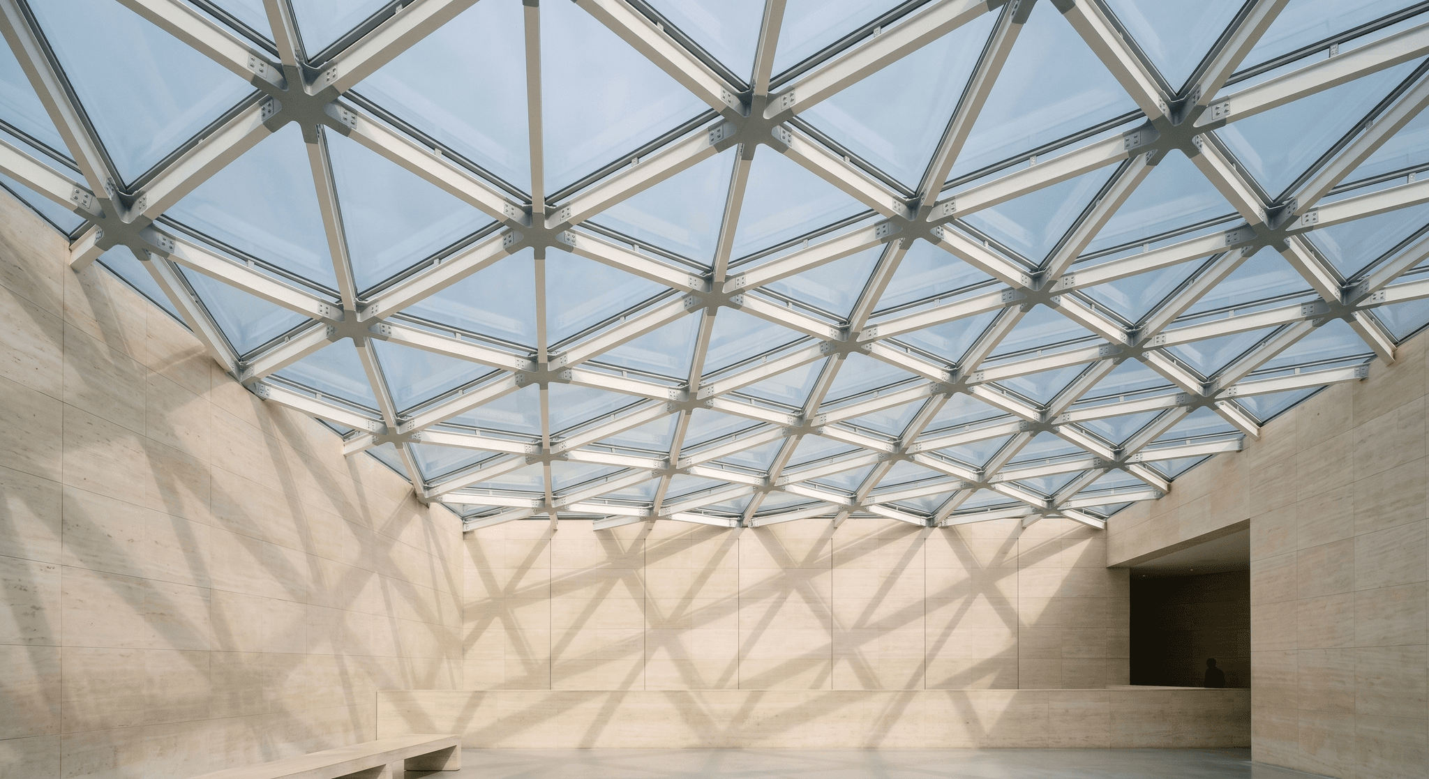 Signature institutional atrium, triangulated diagrid skylight with variable parametric geometry, raking shadows projected on travertine