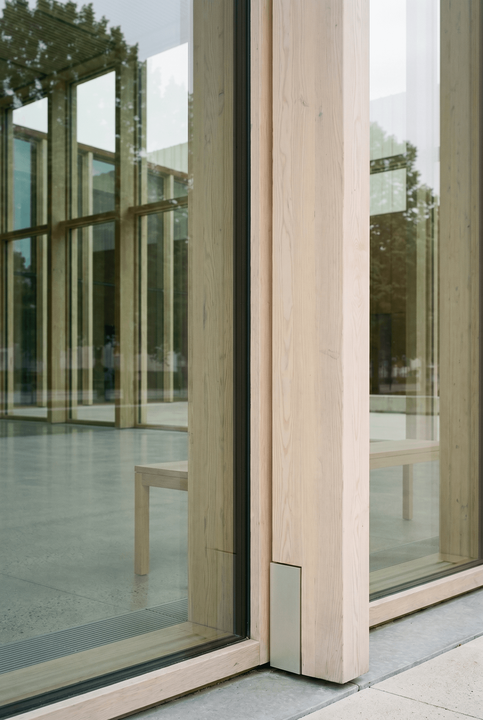 CLT timber and structural glass curtain wall junction, structural silicone SSG joint, pale oak chamfered mullion